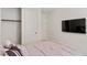 Bedroom featuring a comfortable bed, closet, and a mounted TV at 5081 Notting Hill Ave, Las Vegas, NV 89139