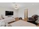 Comfortable bedroom with twin beds, a TV, a massage chair, hardwood floors, and a modern light fixture at 5081 Notting Hill Ave, Las Vegas, NV 89139