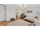 Comfortable bedroom with twin beds, a massage chair, hardwood floors, a modern light fixture, and neutral colors at 5081 Notting Hill Ave, Las Vegas, NV 89139