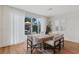 Modern dining area with bright light, hardwood floors, with an outside view of the private yard at 5081 Notting Hill Ave, Las Vegas, NV 89139