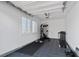 Well-lit garage featuring a home gym with a treadmill, weight bench, and rubber floor mats at 5081 Notting Hill Ave, Las Vegas, NV 89139