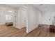 Spacious hallway leading to a bedroom, featuring wood flooring and modern design at 5081 Notting Hill Ave, Las Vegas, NV 89139