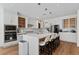 Gourmet kitchen with white cabinetry, quartz countertops, island seating, and stainless steel appliances at 5081 Notting Hill Ave, Las Vegas, NV 89139