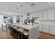 Open concept kitchen and dining area with a large island, stainless appliances, and modern white cabinetry at 5081 Notting Hill Ave, Las Vegas, NV 89139