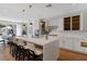 Open-concept kitchen with large island, pendant lighting, white cabinetry and stainless appliances at 5081 Notting Hill Ave, Las Vegas, NV 89139