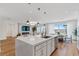 Open layout with spacious kitchen island, dining area, and cozy fireplace, perfect for modern living at 5081 Notting Hill Ave, Las Vegas, NV 89139
