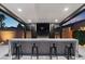 A well-equipped outdoor bar area provides seating, counter space, and a TV for ultimate outdoor entertaining at 5081 Notting Hill Ave, Las Vegas, NV 89139