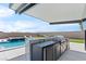 Outdoor kitchen with built-in grill and appliances, adjacent to the pool and spa for ultimate entertaining at 5081 Notting Hill Ave, Las Vegas, NV 89139