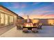 Charming patio featuring a fire pit, comfortable seating, and a serene outdoor ambiance at sunset at 5081 Notting Hill Ave, Las Vegas, NV 89139