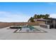 Stunning backyard pool with sun loungers, built-in bar, spa, and lush landscaping creating a private oasis at 5081 Notting Hill Ave, Las Vegas, NV 89139