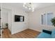 Cozy sitting room with hardwood floors, stylish furniture, and a wall mounted TV at 5081 Notting Hill Ave, Las Vegas, NV 89139