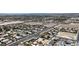 Sprawling aerial shot of neighborhood featuring diverse homes with desert landscape, pools, and city views at 6235 N Fort Apache Rd, Las Vegas, NV 89149