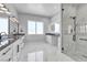 Modern bathroom featuring a marble shower, dual sink vanity, and large window at 6235 N Fort Apache Rd, Las Vegas, NV 89149