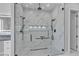 Luxurious marble shower with dual shower heads and pebble tile floor at 6235 N Fort Apache Rd, Las Vegas, NV 89149