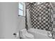 Bathroom boasting modern toilet, and a decorative tiled shower with window at 6235 N Fort Apache Rd, Las Vegas, NV 89149