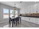 Bright dining area with chandelier, marble floors, and white cabinetry and countertops at 6235 N Fort Apache Rd, Las Vegas, NV 89149