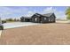 Spacious black exterior home with a large gravel yard, offering ample space and privacy at 6235 N Fort Apache Rd, Las Vegas, NV 89149