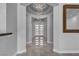 Elegant hallway featuring tile floors, modern chandelier, and contemporary design at 6235 N Fort Apache Rd, Las Vegas, NV 89149