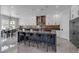 Open kitchen boasts a large island with seating, stainless steel appliances, and decorative backsplash at 6235 N Fort Apache Rd, Las Vegas, NV 89149