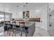 Open-concept kitchen with white cabinets, stainless steel appliances, and a large island with bar seating at 6235 N Fort Apache Rd, Las Vegas, NV 89149
