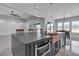 Kitchen island features a copper sink, black countertops, stainless steel appliances, and bar stool seating at 6235 N Fort Apache Rd, Las Vegas, NV 89149