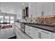 Contemporary kitchen features white cabinets, stainless steel appliances, designer backsplash, and granite countertops at 6235 N Fort Apache Rd, Las Vegas, NV 89149