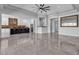 Open-concept living space boasts tile floors, modern lighting, open floor plan, and neutral color scheme at 6235 N Fort Apache Rd, Las Vegas, NV 89149