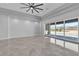 Bright, open living area with sliding glass doors, tile floors, recessed lighting, and fan at 6235 N Fort Apache Rd, Las Vegas, NV 89149