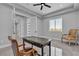 Open office area featuring a modern desk, neutral walls, tile floors, and natural light from a large window at 6235 N Fort Apache Rd, Las Vegas, NV 89149