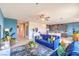 Inviting living room with a blue velvet sofa, open layout, and modern furnishings at 7437 Cooper Cove Dr # 30, North Las Vegas, NV 89084