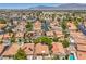 Aerial view of a vibrant residential neighborhood with terracotta roofs, solar panels and private pools at 7772 Buckwood Ct, Las Vegas, NV 89149