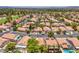 Panoramic aerial view of a community with pools and mature trees create a private, resort-like setting at 7772 Buckwood Ct, Las Vegas, NV 89149