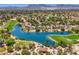 Picturesque aerial view of the community showcasing lush greenery, a serene lake, and the golf course at 7772 Buckwood Ct, Las Vegas, NV 89149