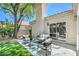 Backyard with artificial grass and a patio next to large glass sliding doors at 7772 Buckwood Ct, Las Vegas, NV 89149