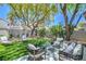 Backyard has artificial grass and comfortable seating for relaxing outside at 7772 Buckwood Ct, Las Vegas, NV 89149