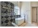 Modern bathroom featuring a stand alone tub and shower with unique decorative tile at 7772 Buckwood Ct, Las Vegas, NV 89149