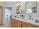 Modern bathroom featuring dual sinks, marble countertops, and a decorative flower arrangement at 7772 Buckwood Ct, Las Vegas, NV 89149