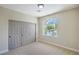 A bright bedroom has a closet with bi-fold doors and an arched window at 7772 Buckwood Ct, Las Vegas, NV 89149