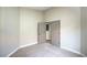Bedroom with neutral carpet and paint and a view to an adjacent room through double doors at 7772 Buckwood Ct, Las Vegas, NV 89149