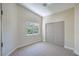Neutral bedroom with a window view and double sliding closet doors at 7772 Buckwood Ct, Las Vegas, NV 89149