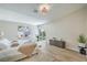 Bright bedroom featuring light hardwood floors and a sliding glass door at 7772 Buckwood Ct, Las Vegas, NV 89149