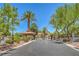 Gated community entrance with lush landscaping, mature trees and meticulous desert rock ground cover at 7772 Buckwood Ct, Las Vegas, NV 89149
