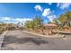Elegant gated community entrance with stone monument sign and mature landscaping at 7772 Buckwood Ct, Las Vegas, NV 89149