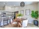 Dining area with wood table set, modern light fixture, light paint, and tile floors at 7772 Buckwood Ct, Las Vegas, NV 89149