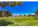 Serene golf course view with lush green grass and a tranquil pond in the distance at 7772 Buckwood Ct, Las Vegas, NV 89149