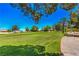 Expansive green space with mature trees and desert landscaping provide a relaxing vista at 7772 Buckwood Ct, Las Vegas, NV 89149