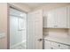 Pass through hallway with door leading to the utility room and a tile floor at 7772 Buckwood Ct, Las Vegas, NV 89149
