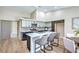 Updated kitchen with modern appliances, an island, updated tile backsplash and light countertops at 7772 Buckwood Ct, Las Vegas, NV 89149
