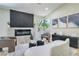 Bright living room with modern fireplace, wood floors, and comfortable seating arrangement at 7772 Buckwood Ct, Las Vegas, NV 89149