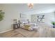 Bright bedroom with wood floors, a large window, and stylish contemporary furniture at 7772 Buckwood Ct, Las Vegas, NV 89149
